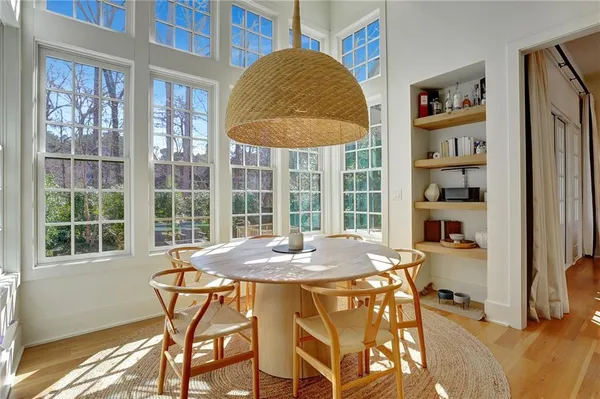a view of a dining room with furniture and a window
