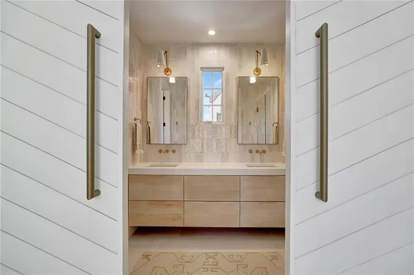 a bathroom with a double vanity sink a mirror and shower
