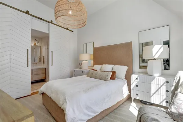 a bedroom with a bed and chandelier