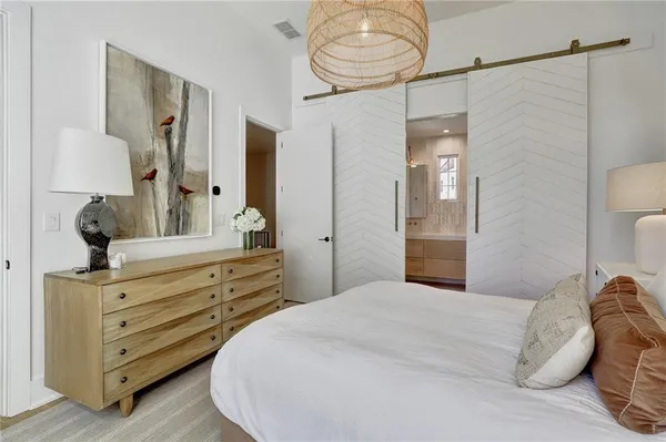 a bedroom with a bed and a chandelier