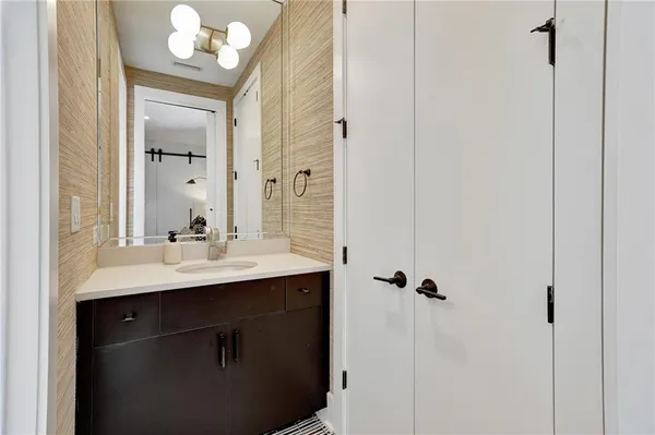a bathroom with a sink vanity and mirror