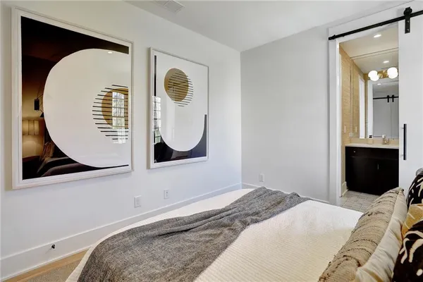 a bedroom with a bed and a mirror