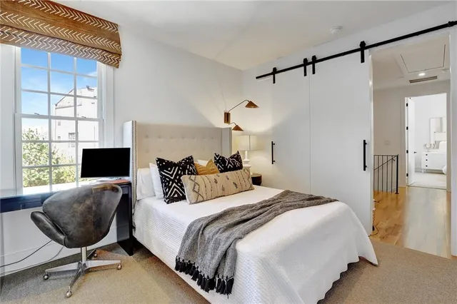 a bedroom with bed and a window