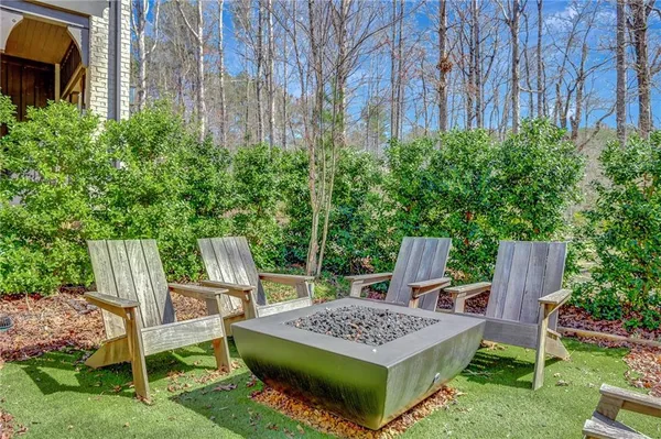 a view of table and chairs in the backyard
