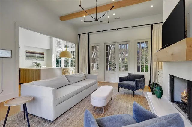 a living room with furniture a fireplace and a flat screen tv