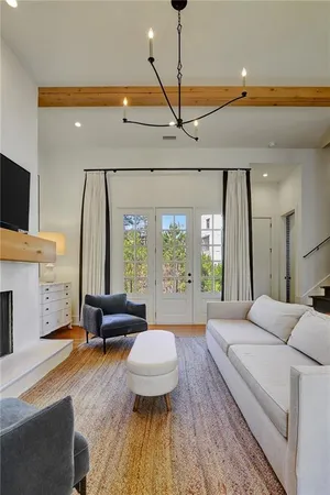 a spacious bedroom with a large bed and a chandelier