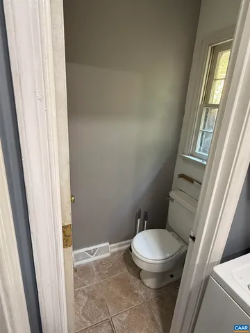 a white toilet sitting next to a window
