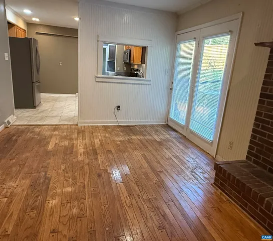 a view of a room with wooden floor