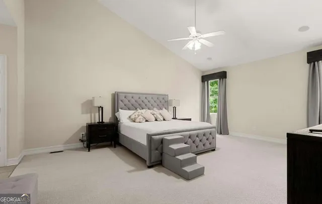 a bedroom with a bed and a ceiling fan