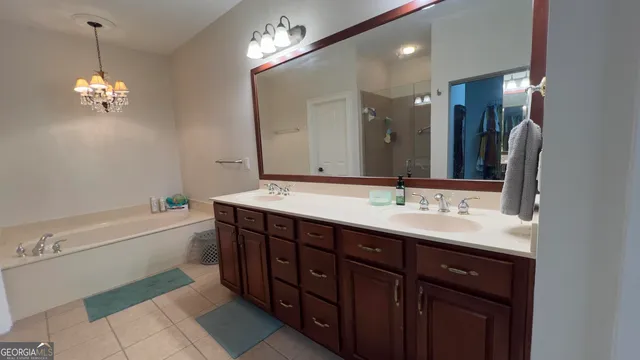 a bathroom with a tub sink and a mirror