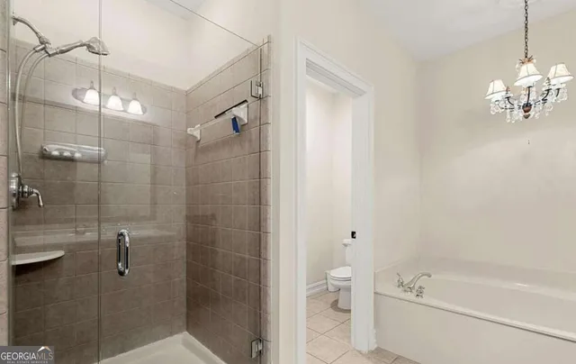 a bathroom with a shower a toilet and a shower