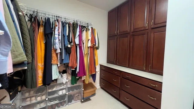 a view of walk in closet with clothes
