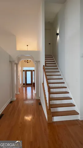 a view of entryway and hall with wooden floor