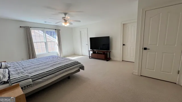 a bedroom with bed and window