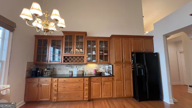 a kitchen with stainless steel appliances granite countertop a refrigerator and a granite countertops