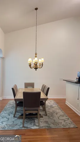 a dining room with furniture and chandelier