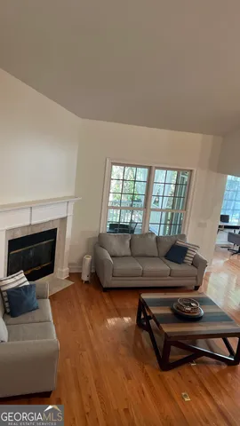 a living room with furniture and a fireplace