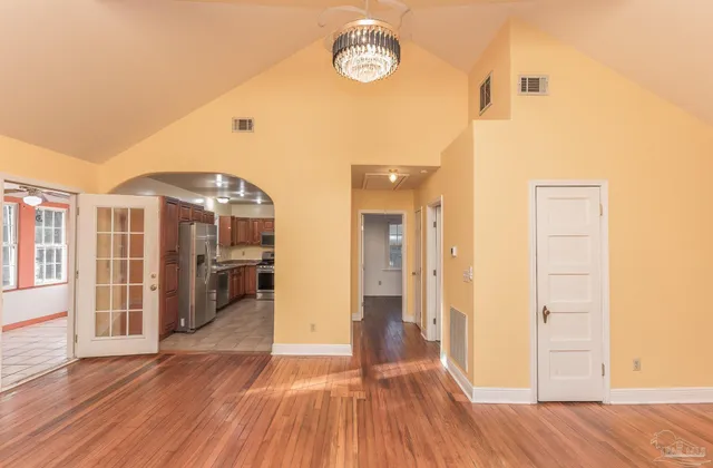 a view of a room with wooden floor