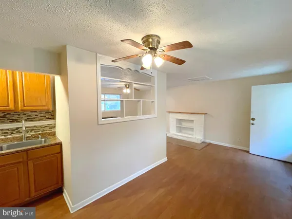a view of empty room with window and ceiling fan