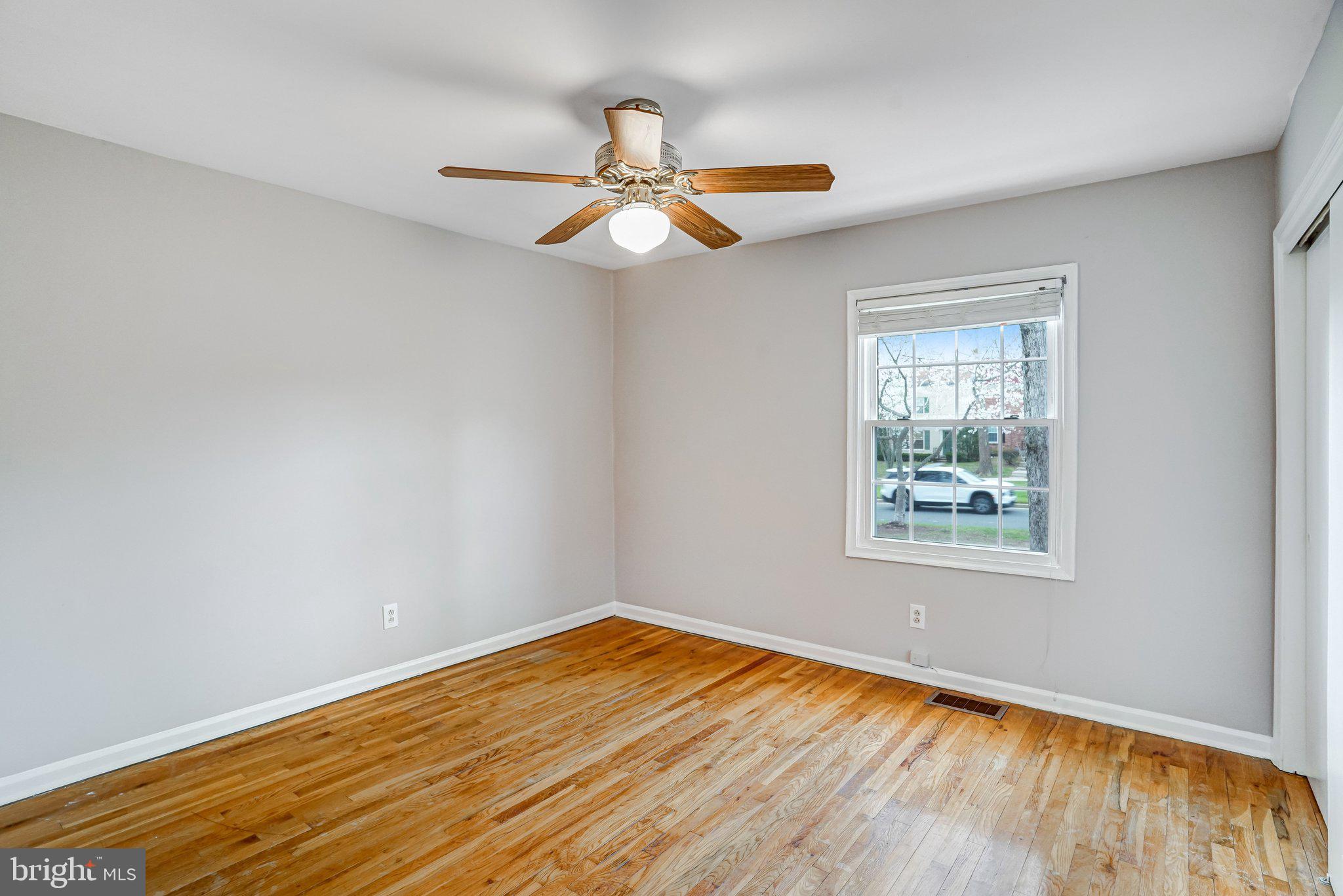 8396 Forrester Boulevard, Unit 555 Springfield, VA 22152 - Photo 17 of 24 a view of empty room with wooden floor and fan