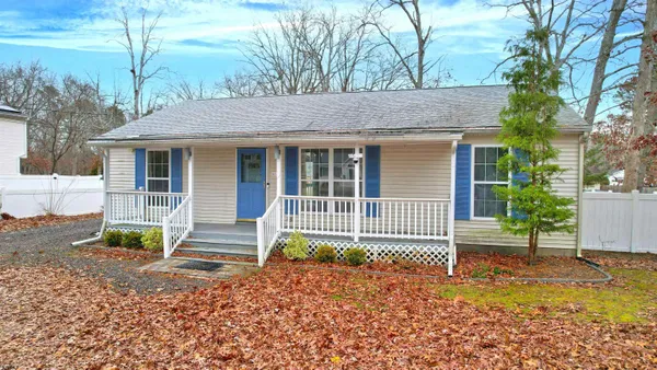 a big room with wooden floor and a kitchen