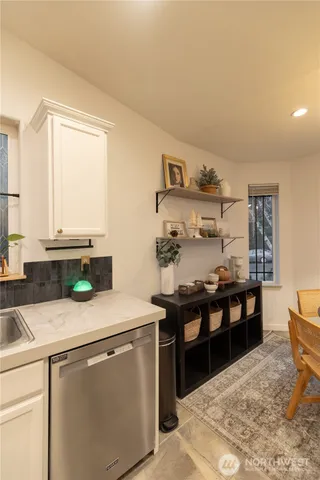 a kitchen with stainless steel appliances kitchen island granite countertop a sink and cabinets