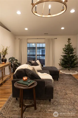 a living room with furniture a chandelier and a fireplace