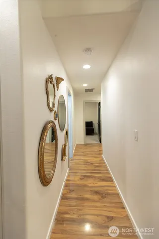 a view of a hallway with wooden floor