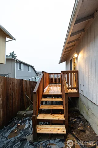 a view of balcony with wooden floor and fence