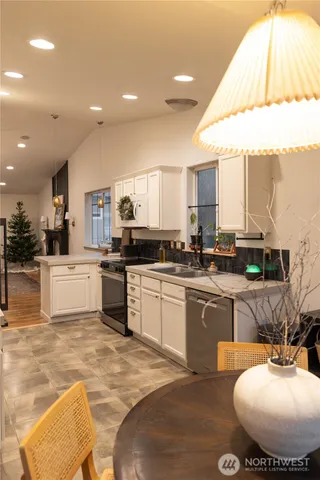a kitchen with stainless steel appliances kitchen island granite countertop a sink and cabinets