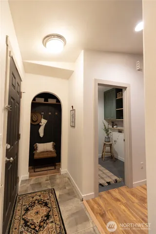 a kitchen with stainless steel appliances kitchen island granite countertop a sink and white cabinets