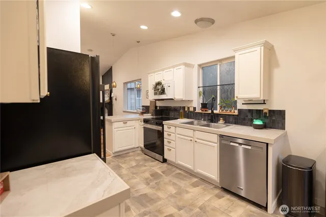 a kitchen that has a stove and a table in it