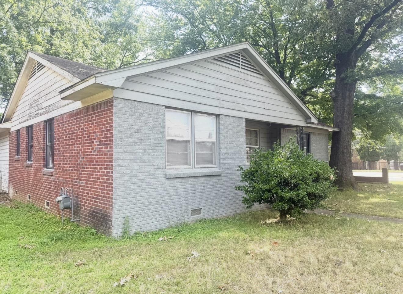 2930 Getwell Road Memphis, TN 38118 - Photo 3 of 25 Exterior featuring a blend of red brick and painted grey brick siding, multiple windows, and a prominent gable roofline