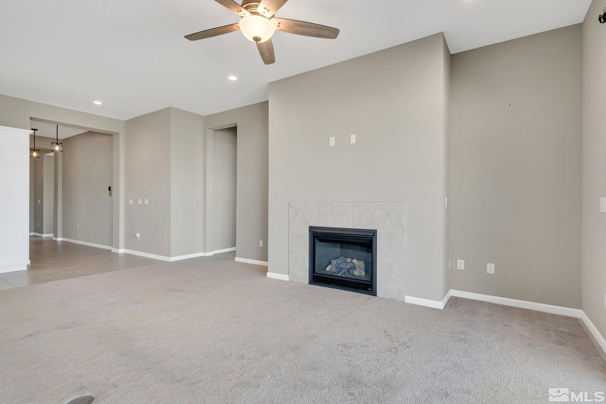 3011 Country Wind Lane Reno, NV 89521 - Photo 8 of 40 an empty room with a fireplace and fan