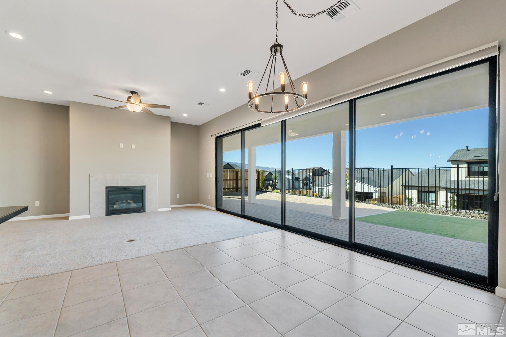 3011 Country Wind Lane Reno, NV 89521 - Photo 10 of 40 a view of an entryway with a floor to ceiling window and a kitchen