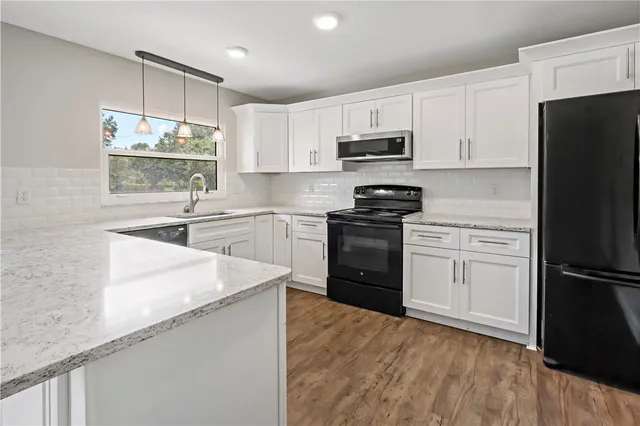 a kitchen with a refrigerator a sink and a stove