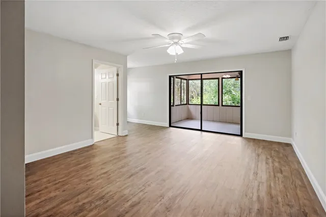 a view of an empty room with glass door