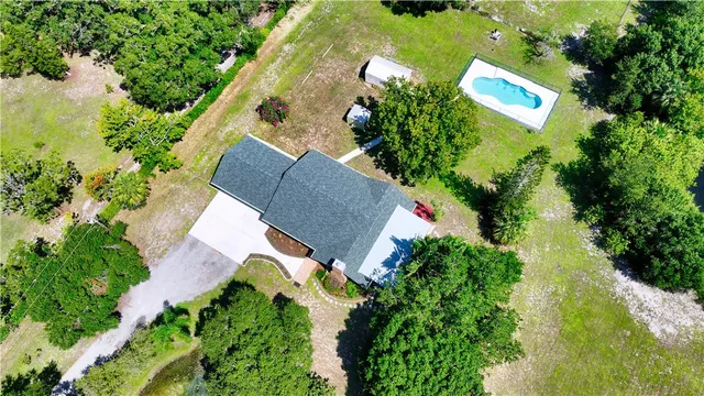 an aerial view of a house with a yard and lake view