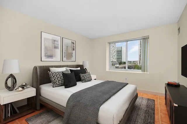 a bedroom with a bed and a window