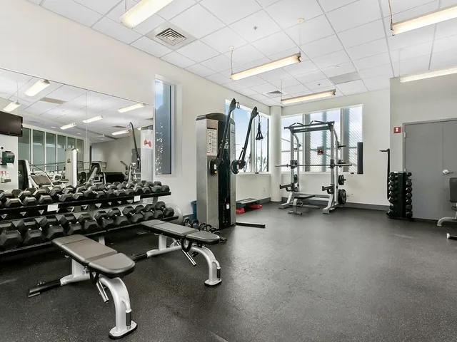 a room with gym equipment and a large window