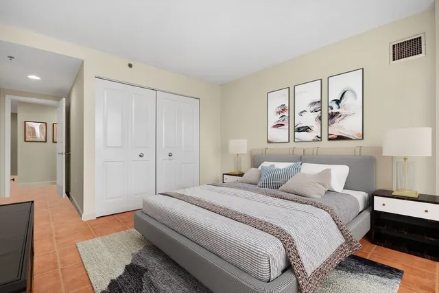 a bedroom with a bed and a painting on the wall