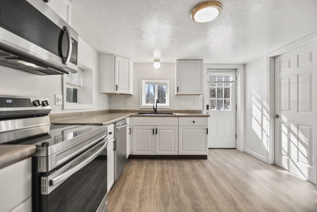 800 Patriots Road Templeton, MA 01468 - Photo 7 of 31 a kitchen with granite countertop a stove sink and cabinets