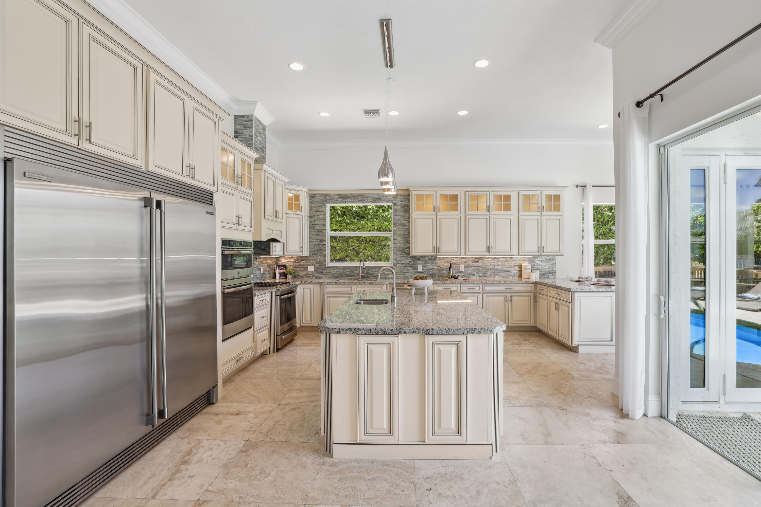 1030 Rhodes Villa Avenue Delray Beach, FL 33483 - Photo 13 of 76 a large kitchen with cabinets and stainless steel appliances