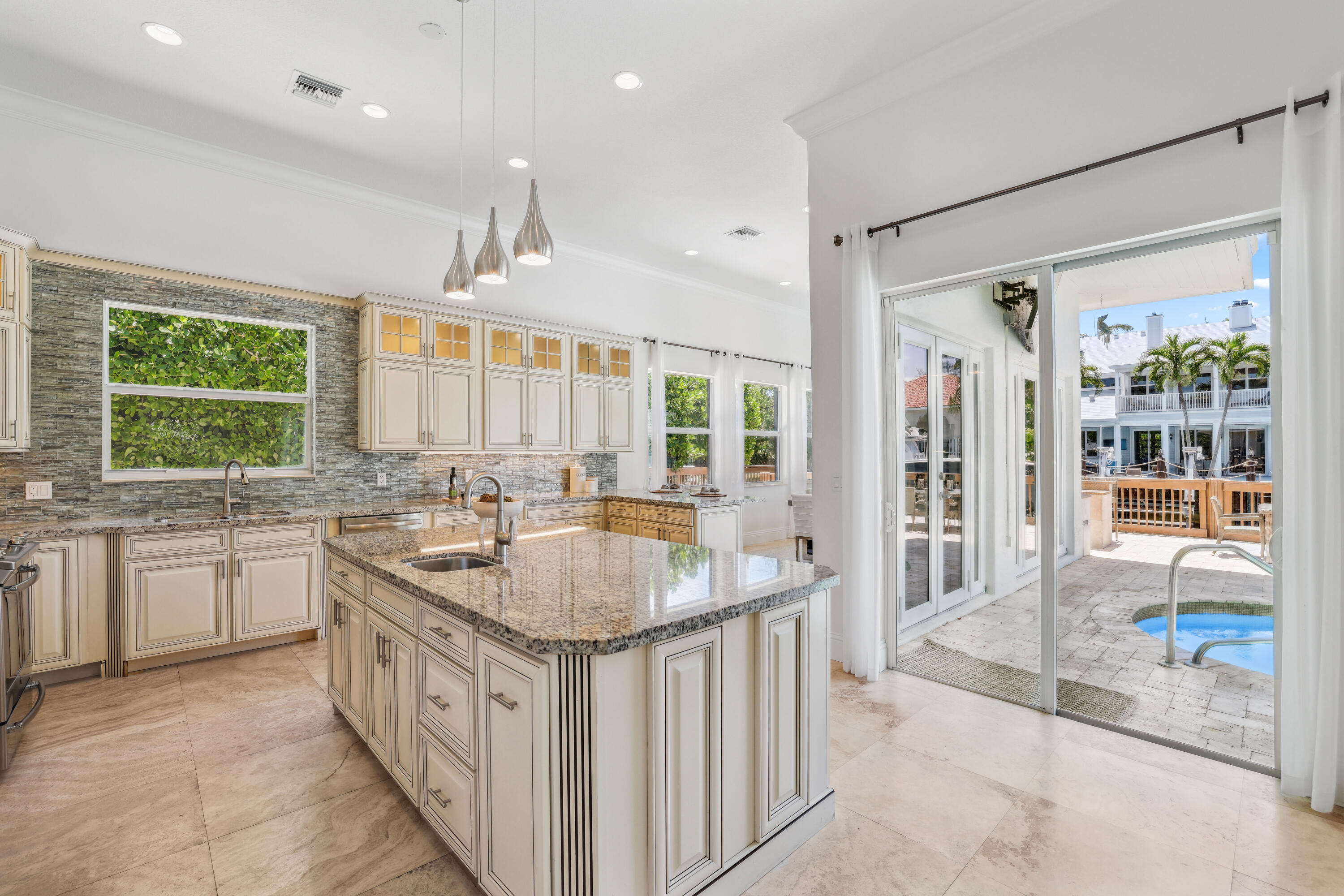 1030 Rhodes Villa Avenue Delray Beach, FL 33483 - Photo 14 of 76 a kitchen with stainless steel appliances granite countertop a sink and a large window
