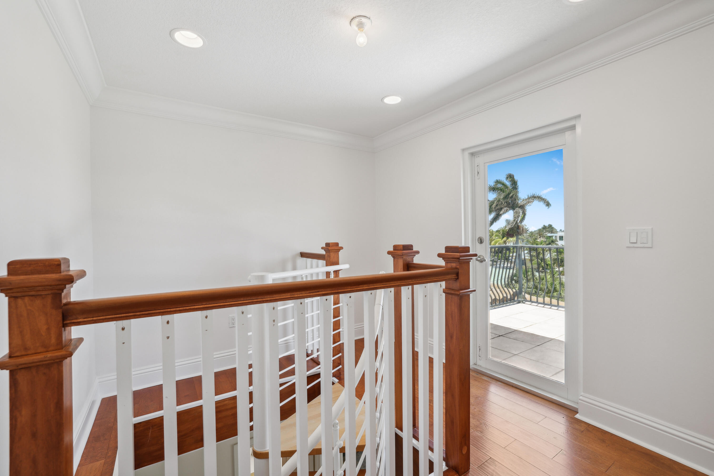 1030 Rhodes Villa Avenue Delray Beach, FL 33483 - Photo 68 of 76 a view of a hallway with wooden floor and a bathroom