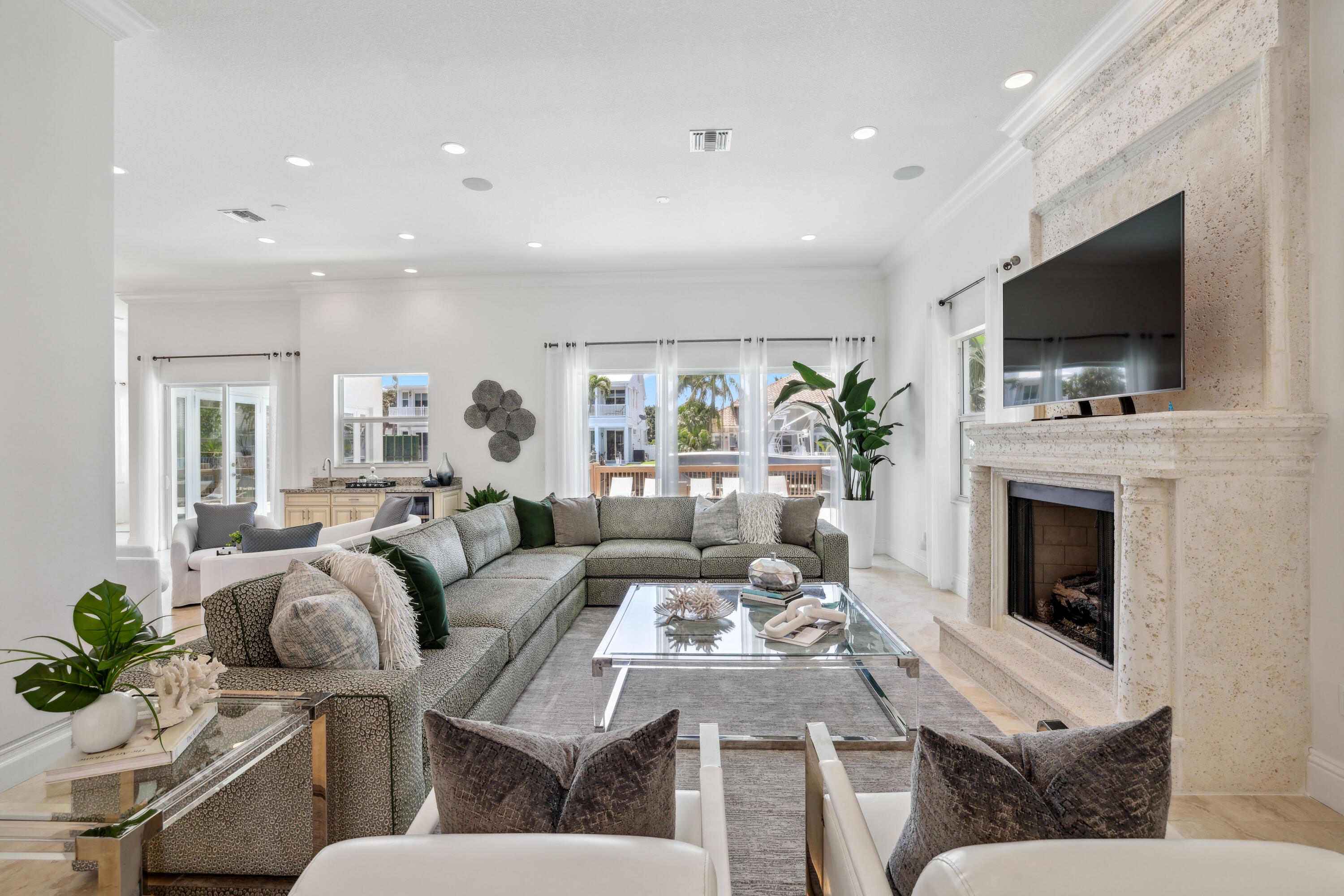 1030 Rhodes Villa Avenue Delray Beach, FL 33483 - Photo 8 of 76 a living room with furniture a flat screen tv and a fireplace