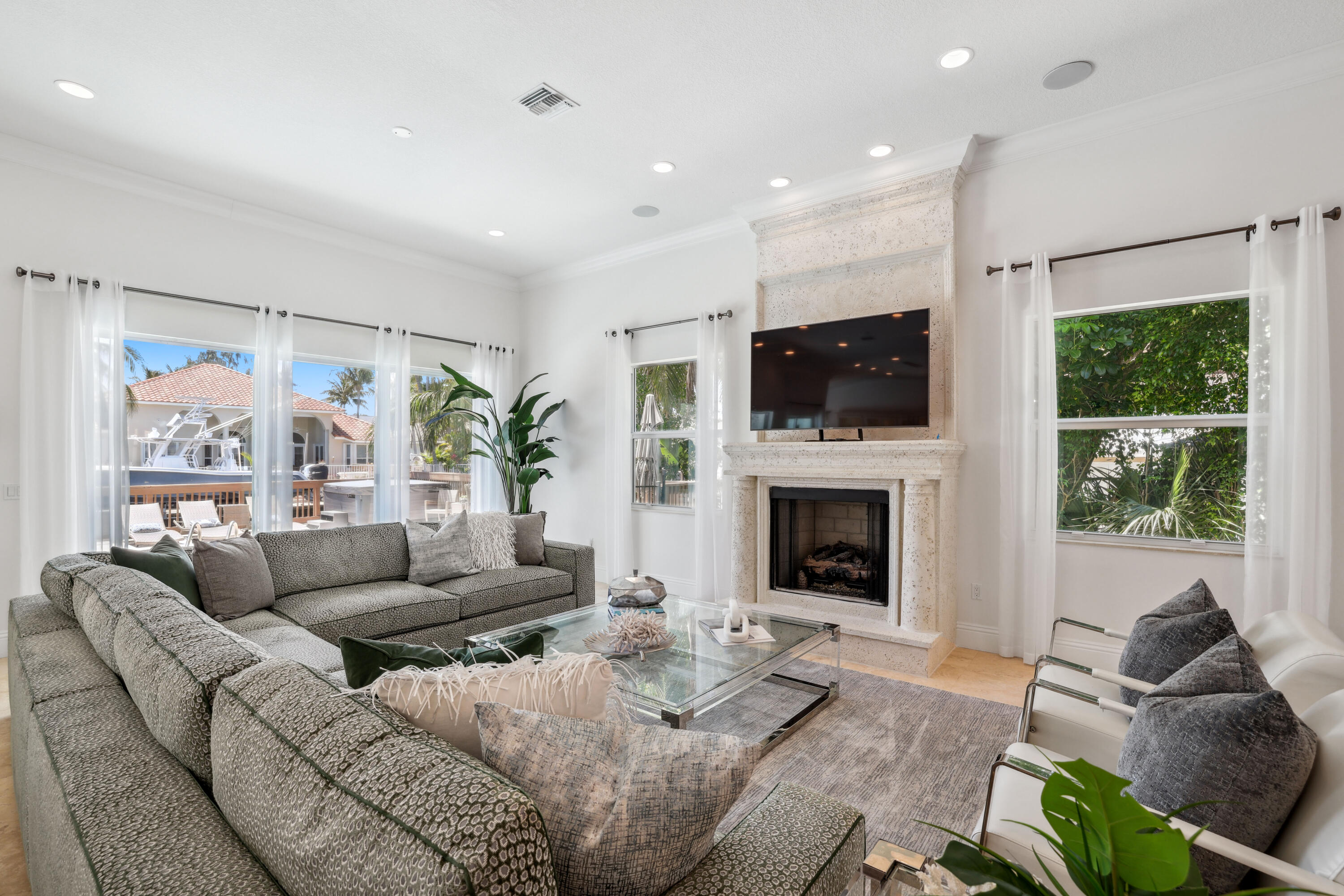 1030 Rhodes Villa Avenue Delray Beach, FL 33483 - Photo 9 of 76 a living room with furniture a fireplace and a flat screen tv