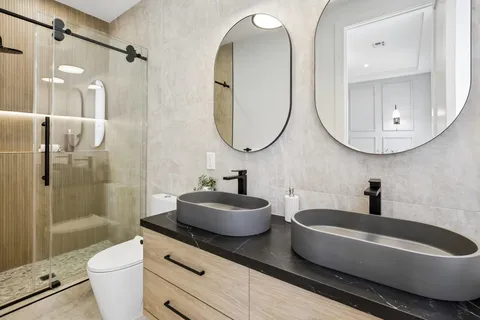a bathroom with a sink a toilet and a mirror