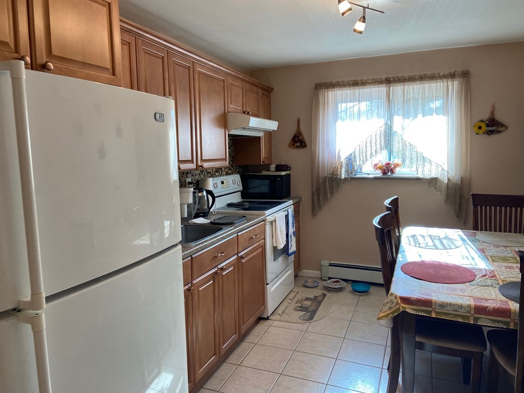 14 Bryon Road, Unit 3 Boston, MA 02467 - Photo 8 of 9 a kitchen with a refrigerator and a stove top oven