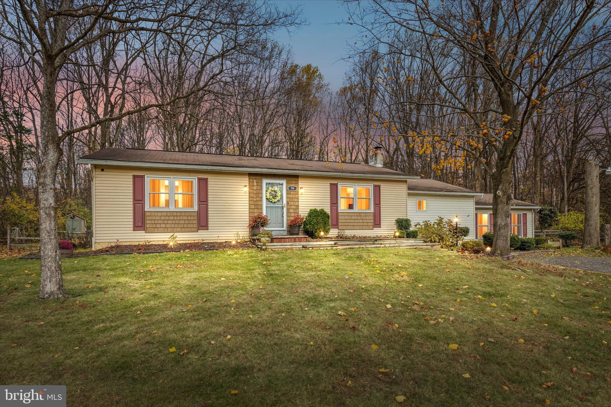 a view of a house with a yard and sitting area